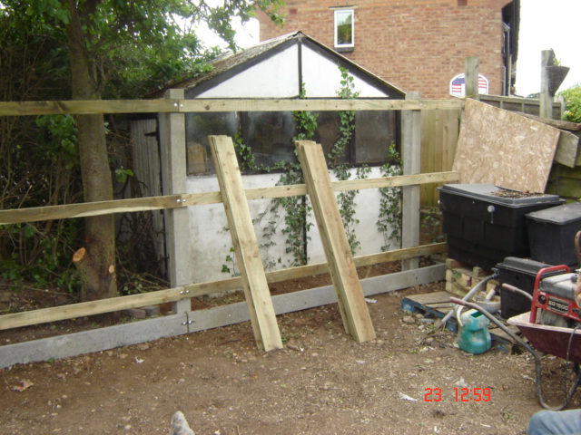 Awkward due to outbuildings and trees but featherboard fencing is very versatile