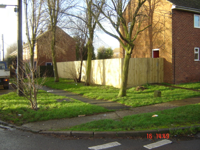 Close board wood fencing with wooden posts and handmade gate Lighthorne Heath
