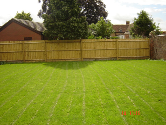 Large run of feather board fencing in Barford